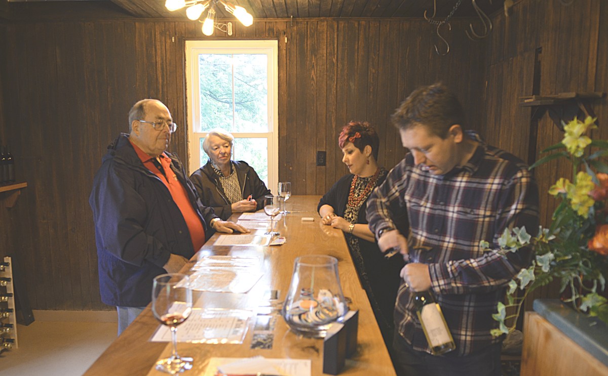 Visitors at the tasting bar in Deerfoot's former summer kitchen.
